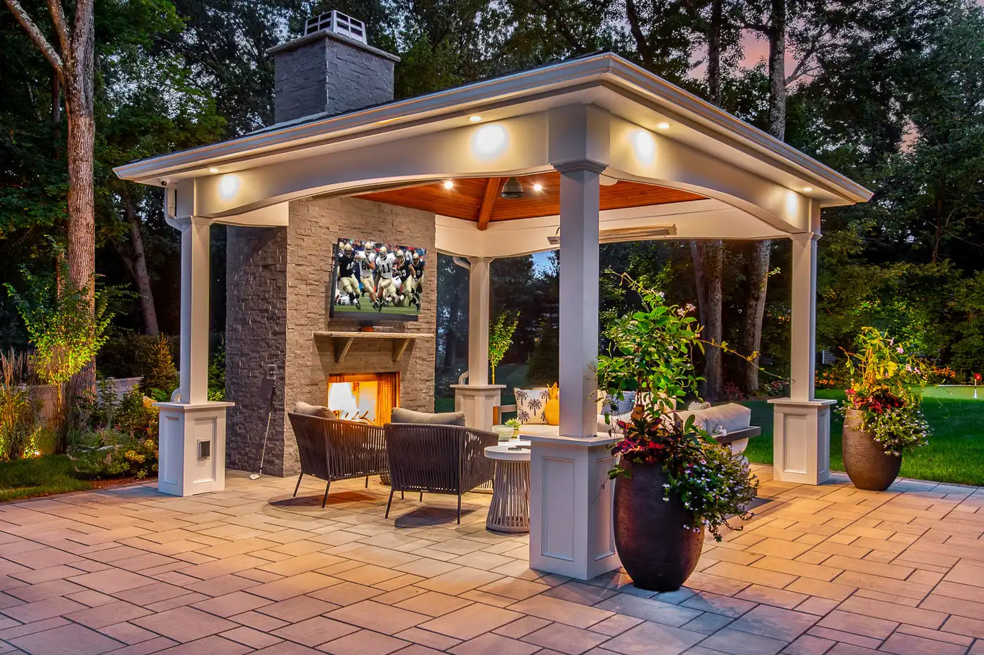 Outdoor fireplace with adjacent dining area NJ by CLC.