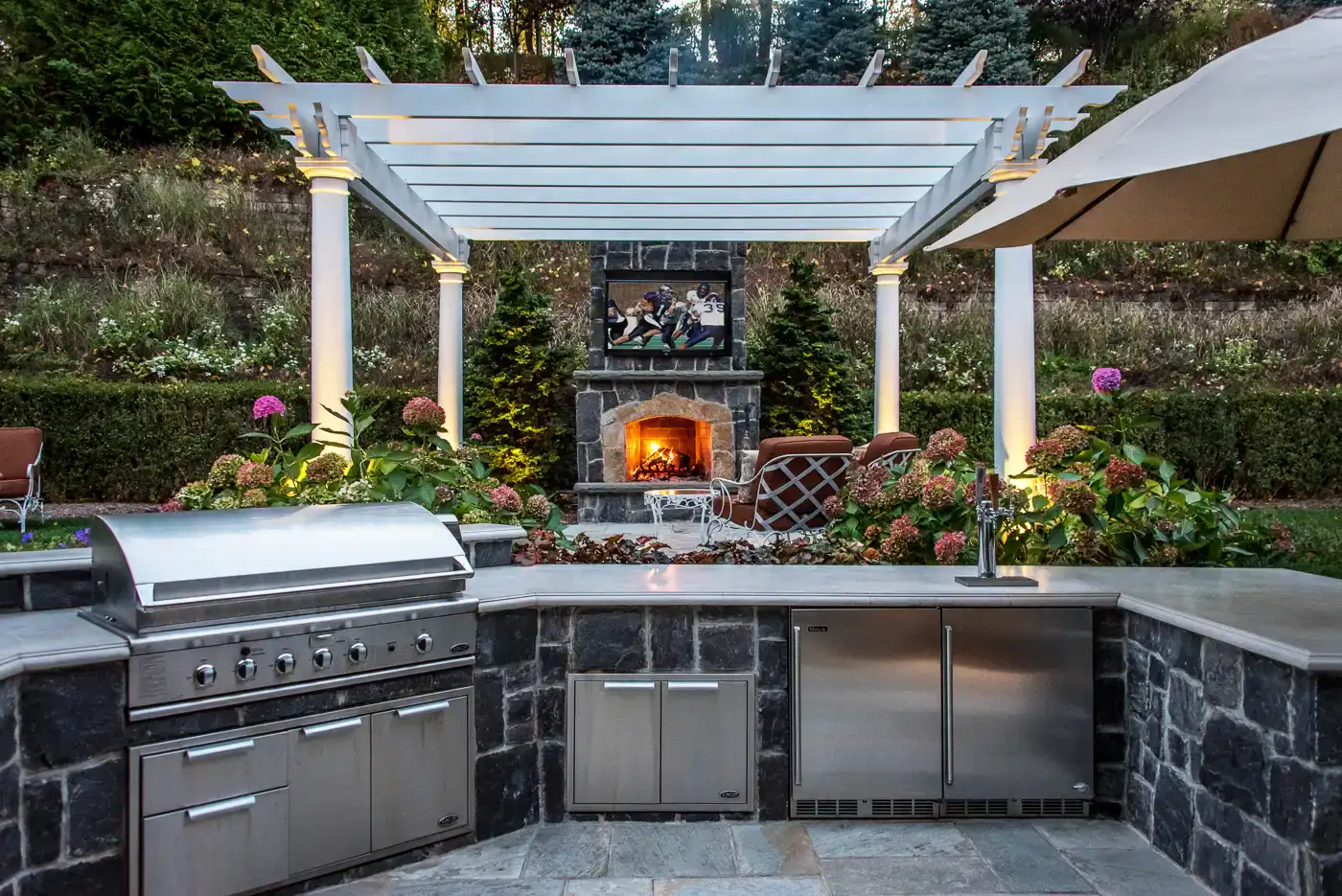 Outdoor kitchen with grill and stone counters—CLC Landscape Design NJ.