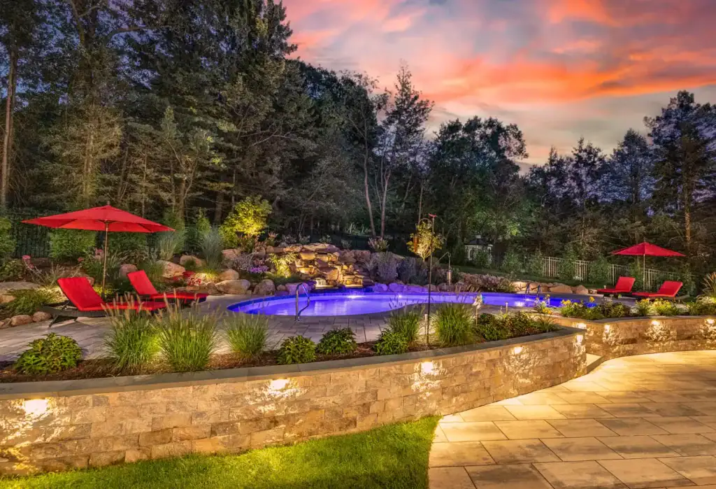 In-ground swimming pool with surrounding landscape and seating areas by CLC Landscape Design, New Jersey pool and landscape contractors in Denville.