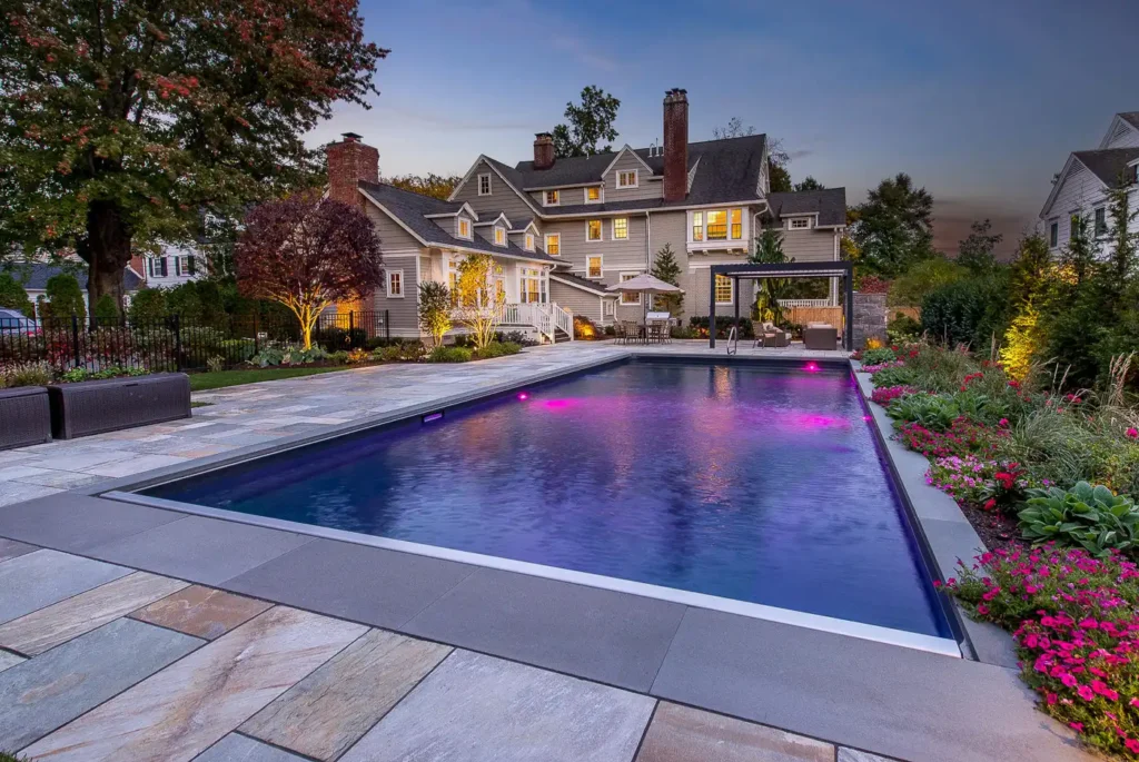 Luxury backyard pool design in Montclair, New Jersey by CLC Landscape Design featuring custom hardscaping, clean lines, and a refined outdoor living space