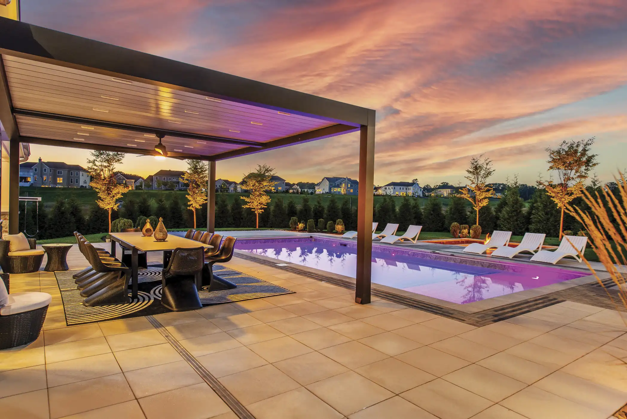 High-end swimming pool installation with natural stone patio in Upper Saddle River NJ landscape design project